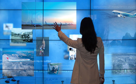 Woman in front of a large computer screen