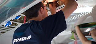 Person in Boeing t-shirt working on product